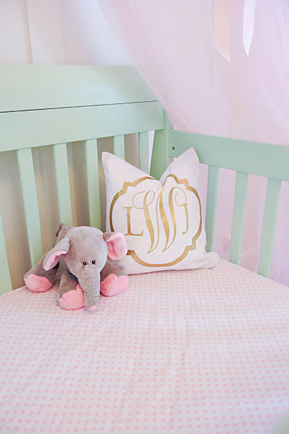 This gold monogrammed crib pillow is to die for! | See the entire nursery at One Small Child: www.onesmallchild.com