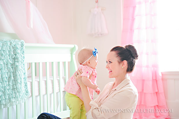 Cute baby Lyla with her mommy in her beautiful pink and aqua baby room | See the entire nursery at One Small Child: www.onesmallchild.com