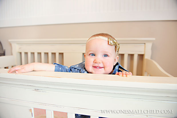 Love Lilys distressed cream colored crib!  See the rest of Lilys nursery at   - One Small Child