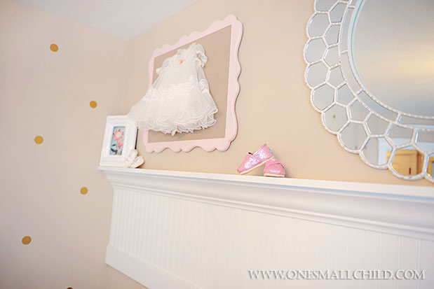 Pretty wainscot shelf display with corkboard for a girl’s room! | See the rest of baby Lily’s nursery at One Small Child: www.onesmallchild.com